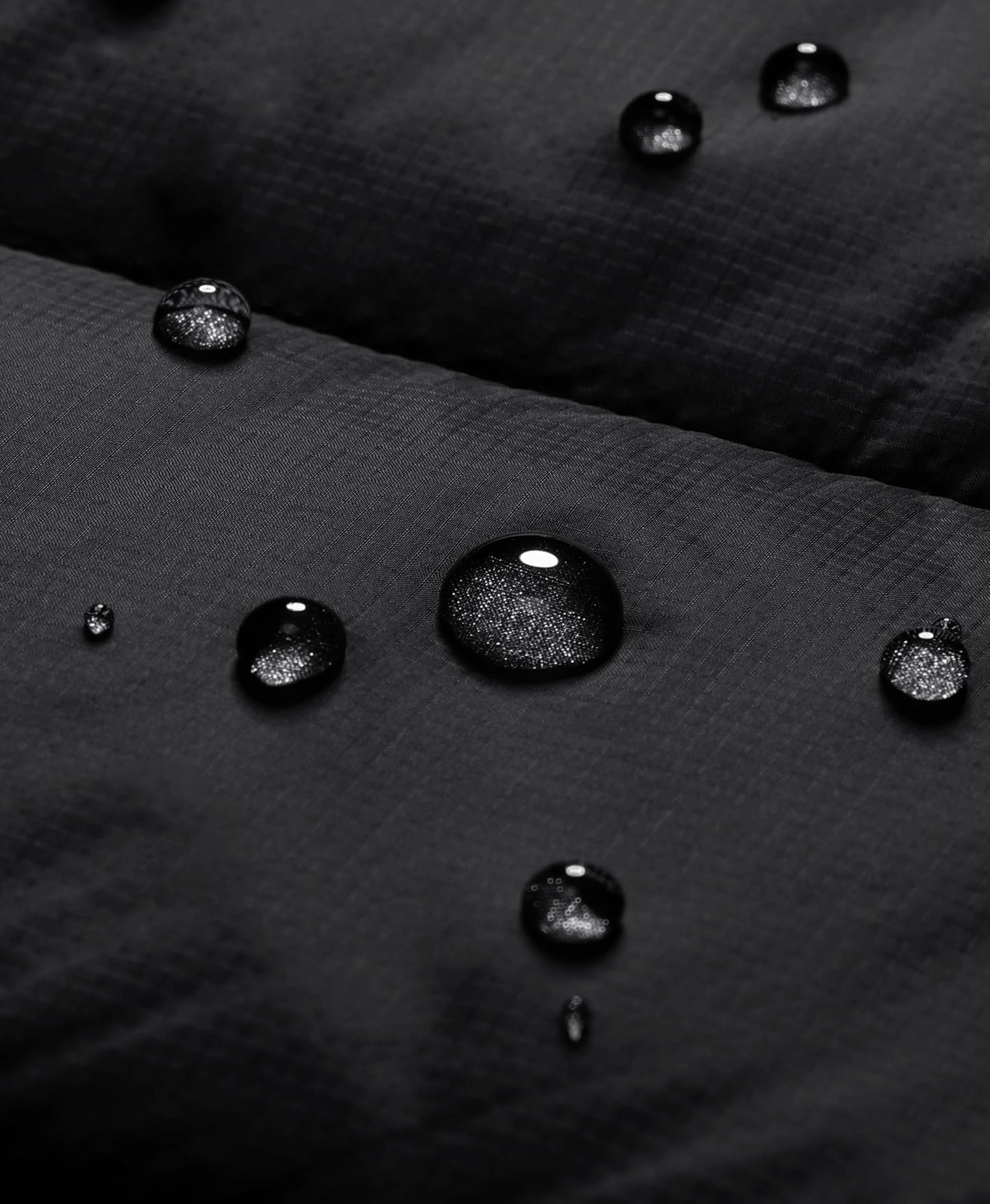 Close-up of black ororo heated vest fabric showing water-resistant surface