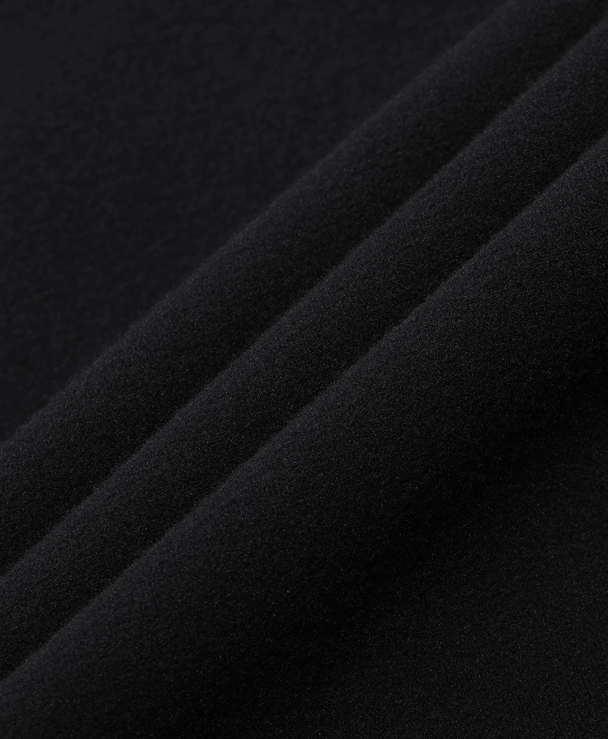 Close-up of the black fabric texture of an ororo heated base layer top.