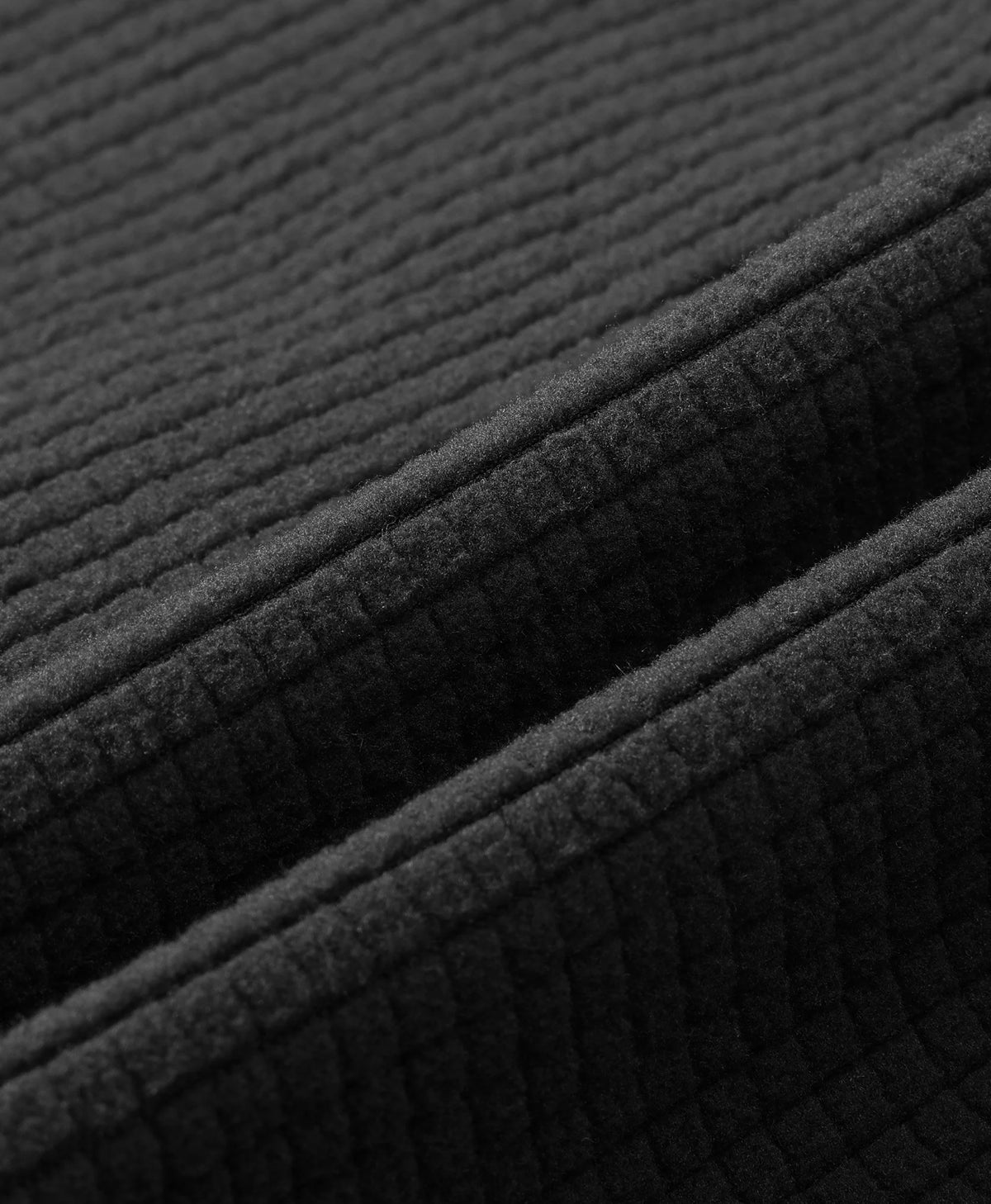 Close-up of Prestige Men's 4-Zone Heated Fleece V-Neck Liner Vest showing Stretchy Knit Fabric