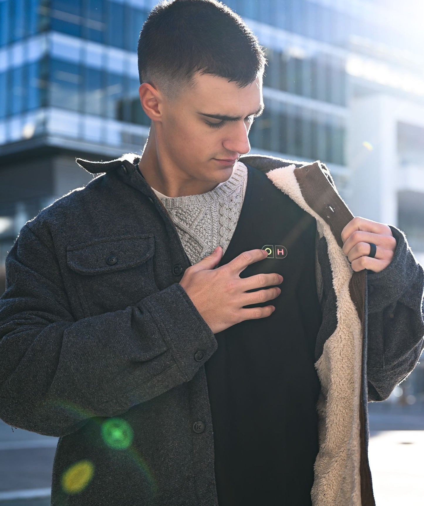 A man wears the vest as an inner layer under a jacket.