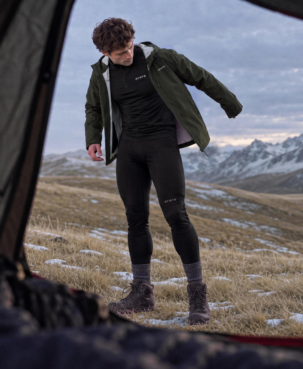 Man wearing ororo heated baselayers at mountain campsite