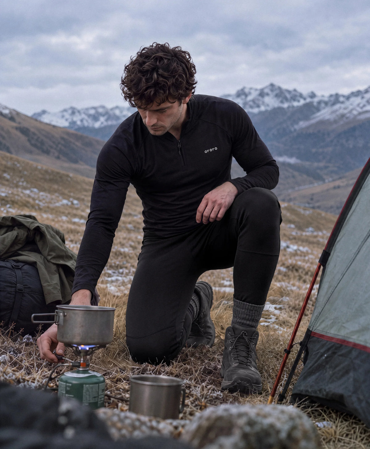 Man wearing ororo heated baselayers at mountain campsite