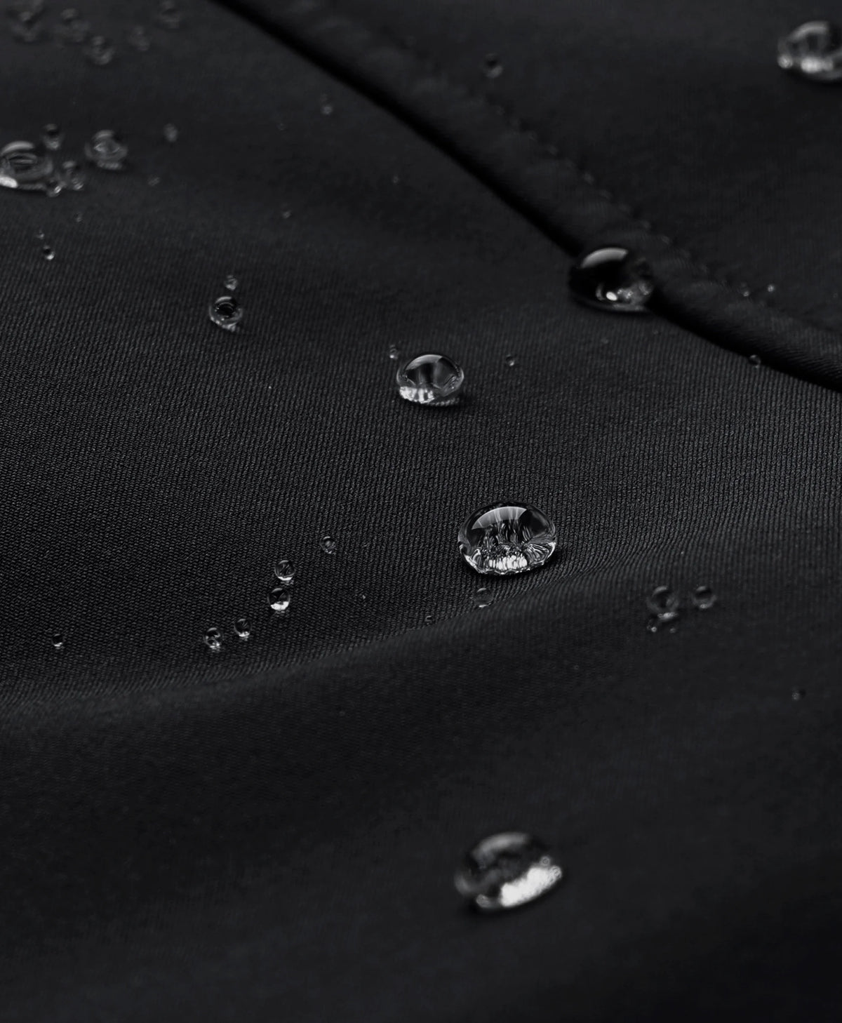 Water droplets beading on the black outer fabric of the ororo Women's Classic Heated Jacket