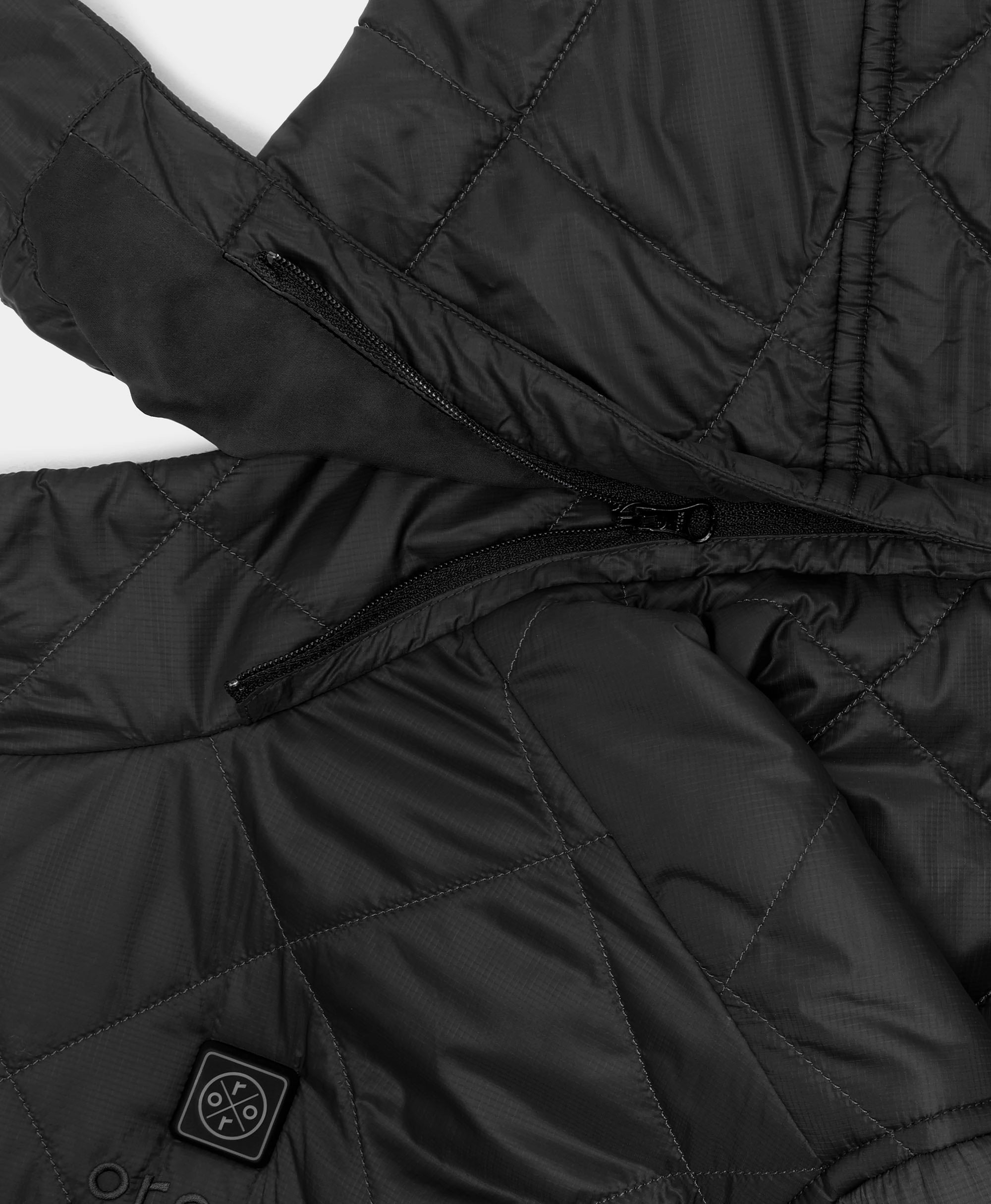Close-up of a black quilted puffer jacket with a black zipper