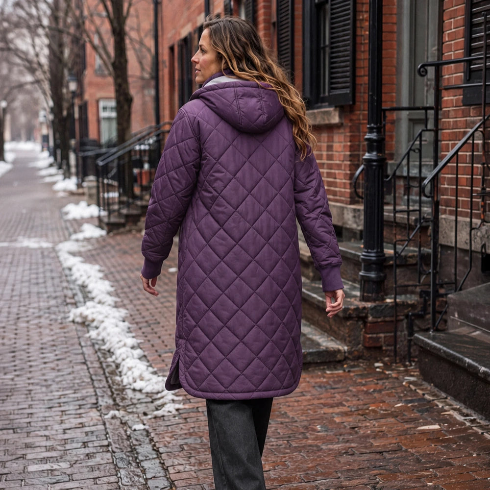 Uptown Women's 4-Zone Heated Parka in purple, back view while walking on a snowy city street