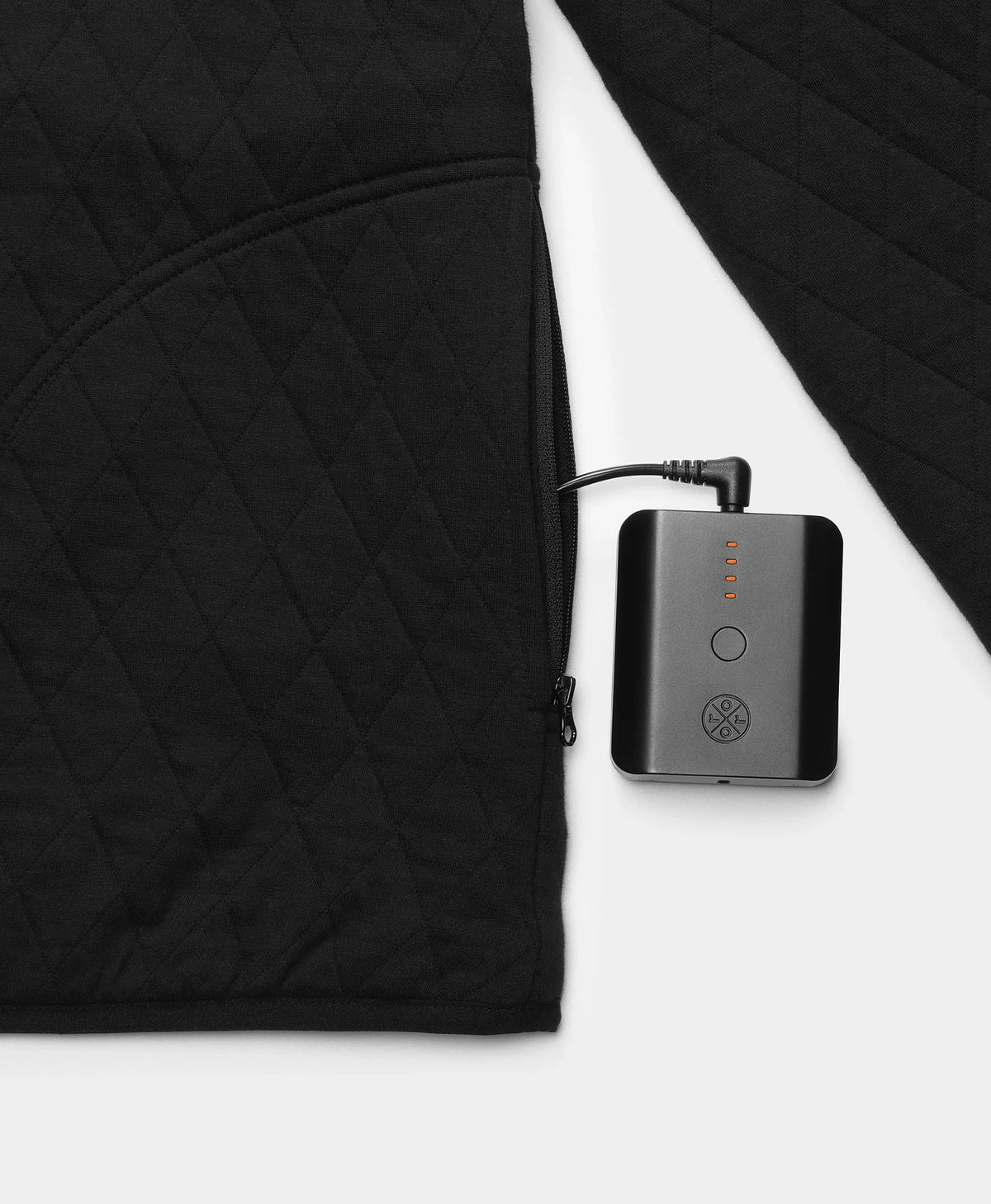 Close-up of a battery pack connected to an ororo black quilted heated pullover.