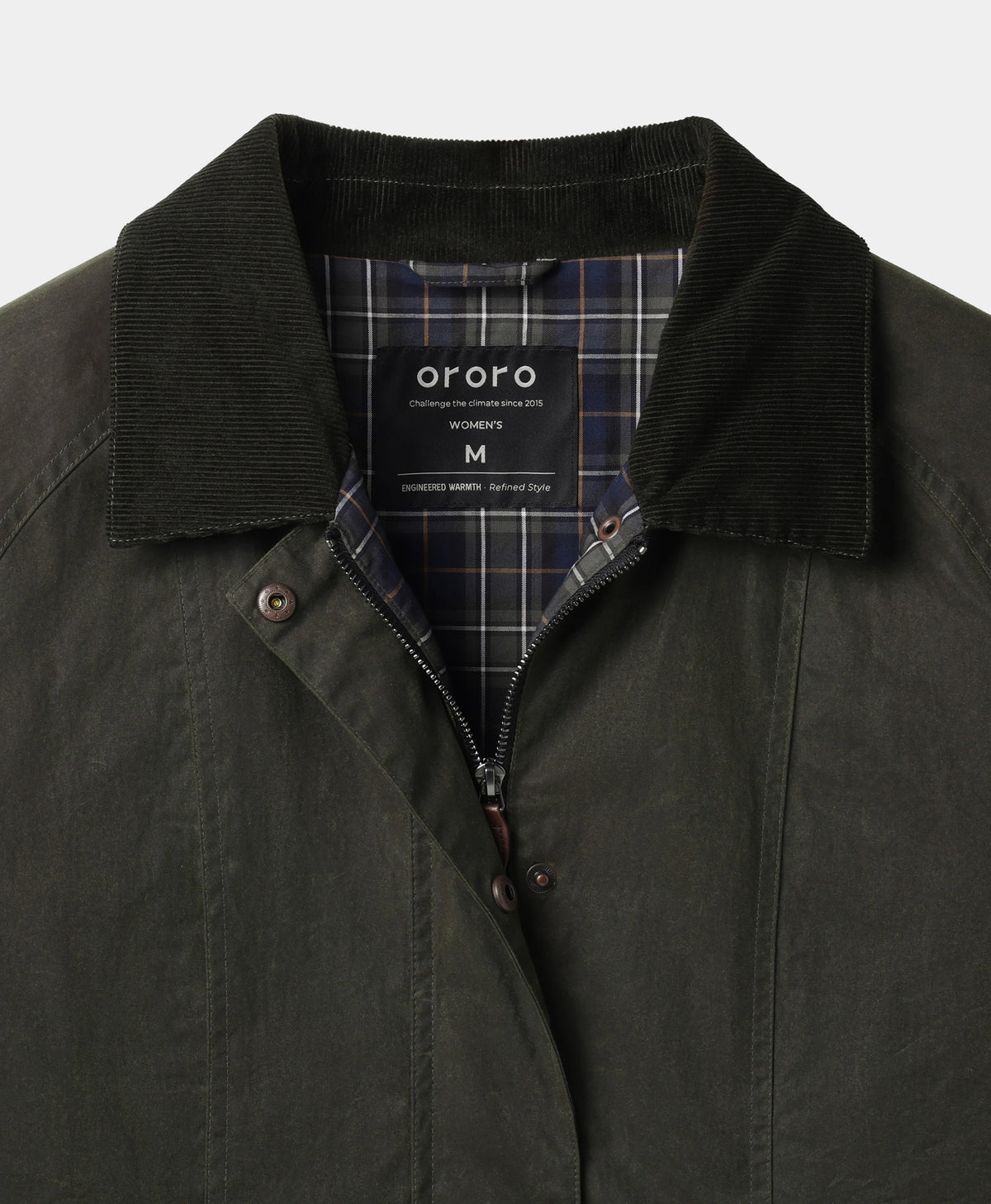 Close-up of an olive green waxed cotton jacket with a dark corduroy collar