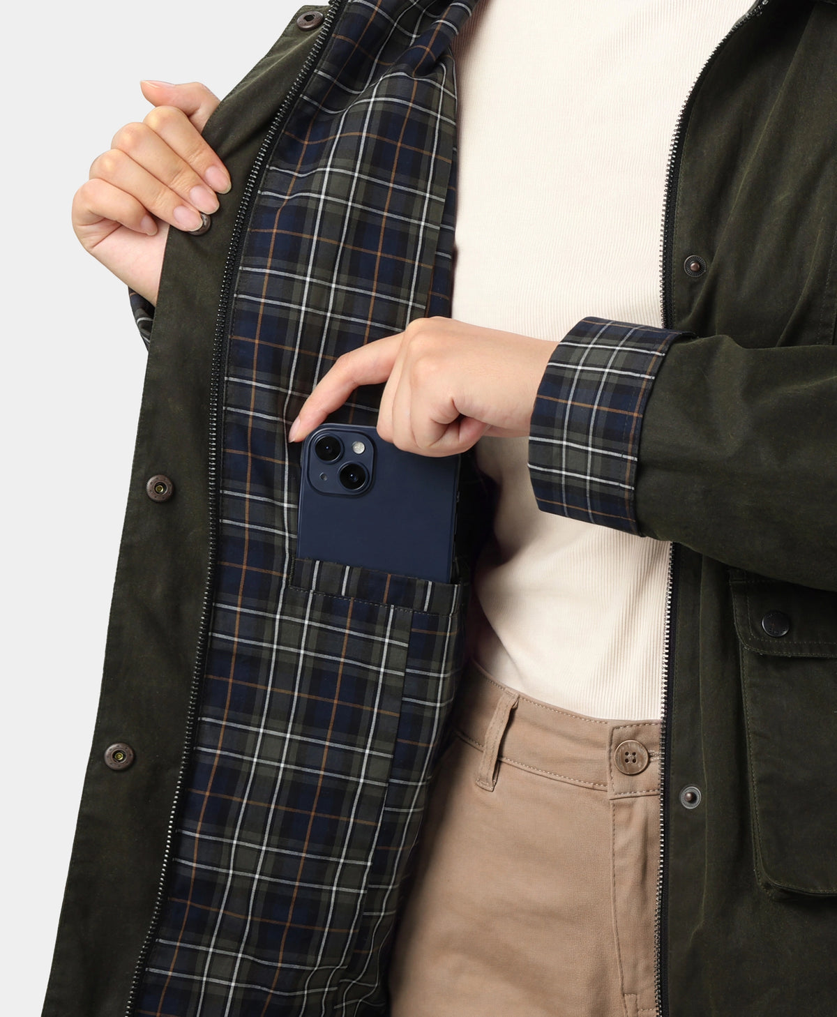 Close-up of phone inside jacket interior pocket with plaid lining