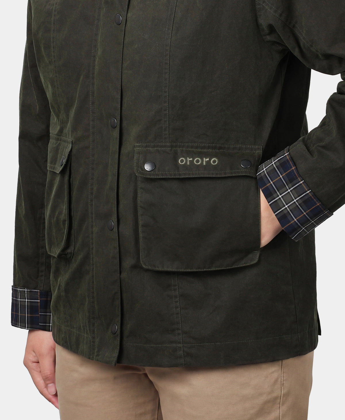 Side pocket detail on ororo dark green jacket with plaid cuff accent