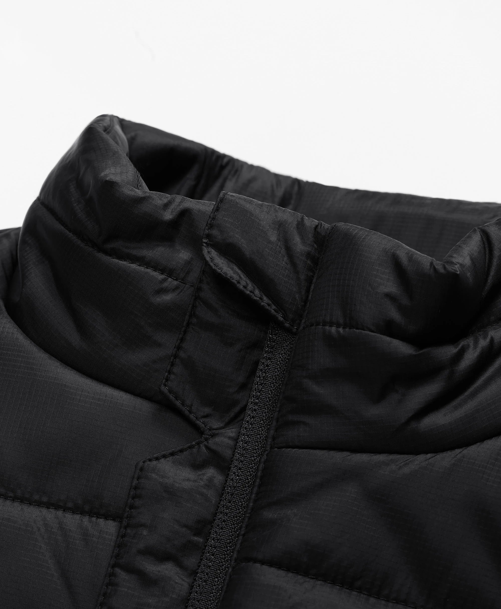 Full-zip vest with a zip-through, stand-up collar for added versatility and warmth.