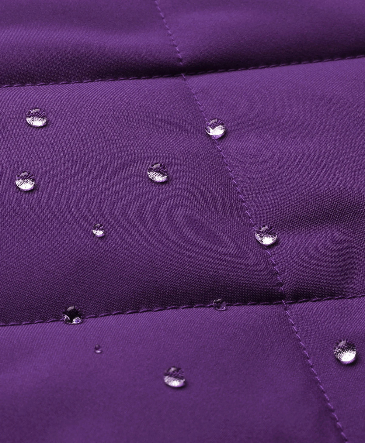 Close-up of violet quilted fabric on ororo Women's Heated Quilted Vest with water droplets