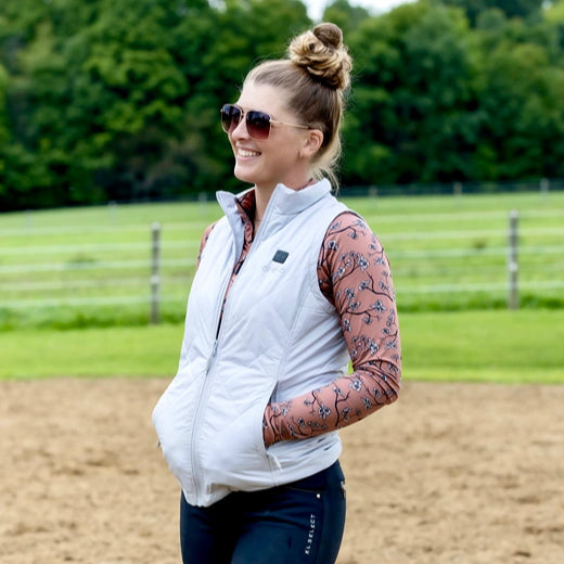 A women wearing a white ororo quilted heated vest
