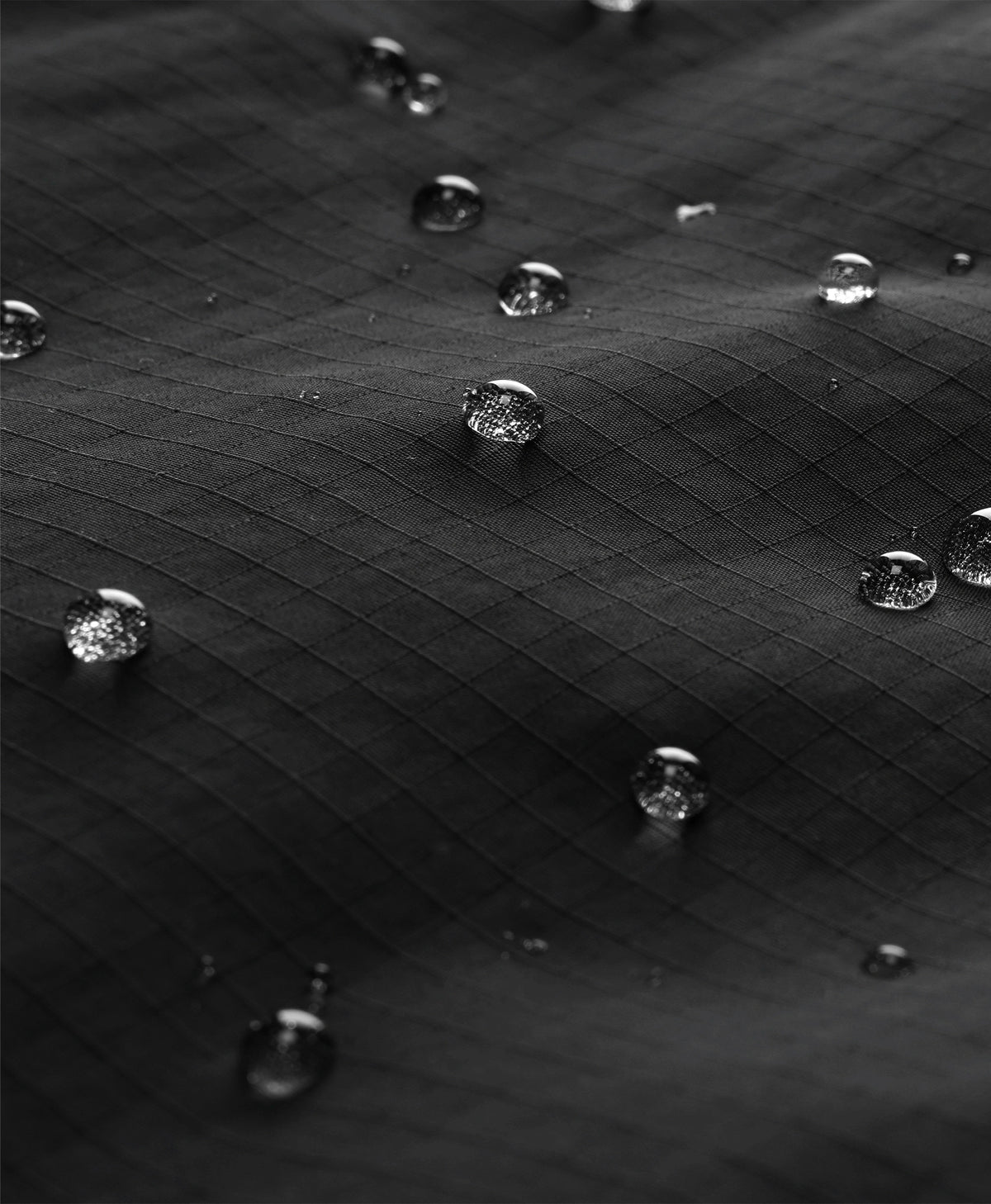 water droplets on ripstop fabric showing water-resistant ororo surewarm jacket shell