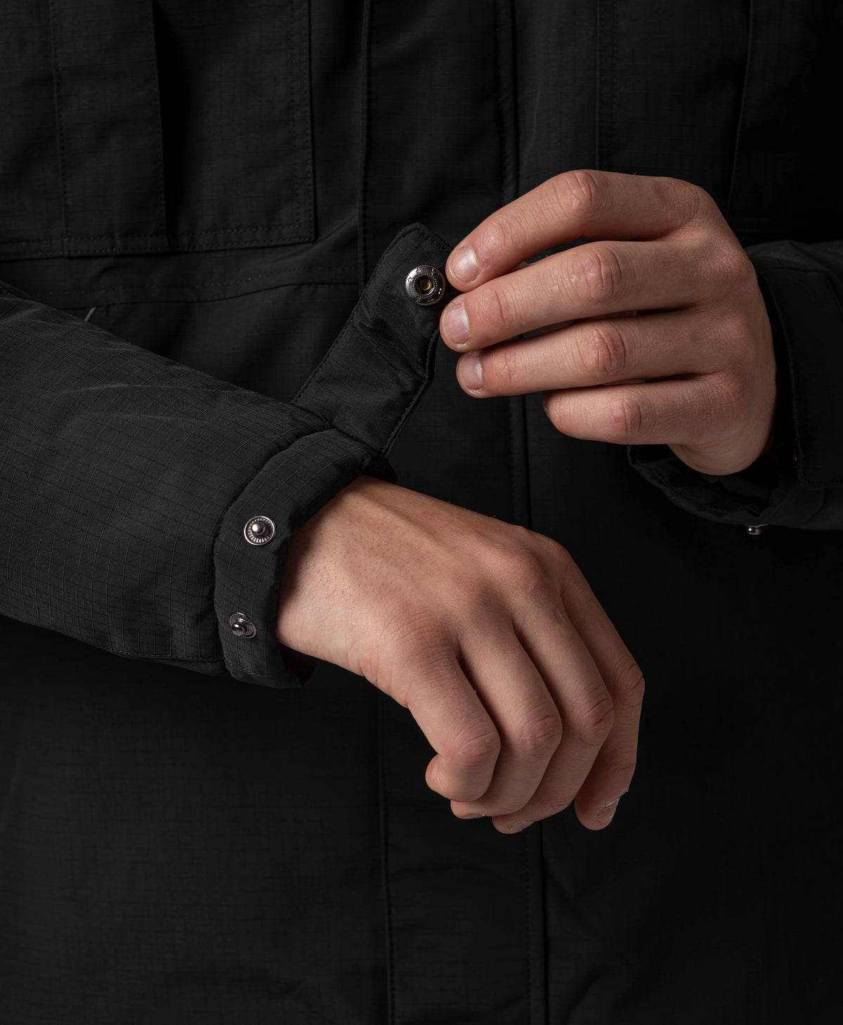 Adjustable snap cuff detail on men's heated jacket sleeve