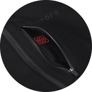 Close-up of zippered pocket on black fleece jacket revealing internal battery connection port, with subtle ororo logo above