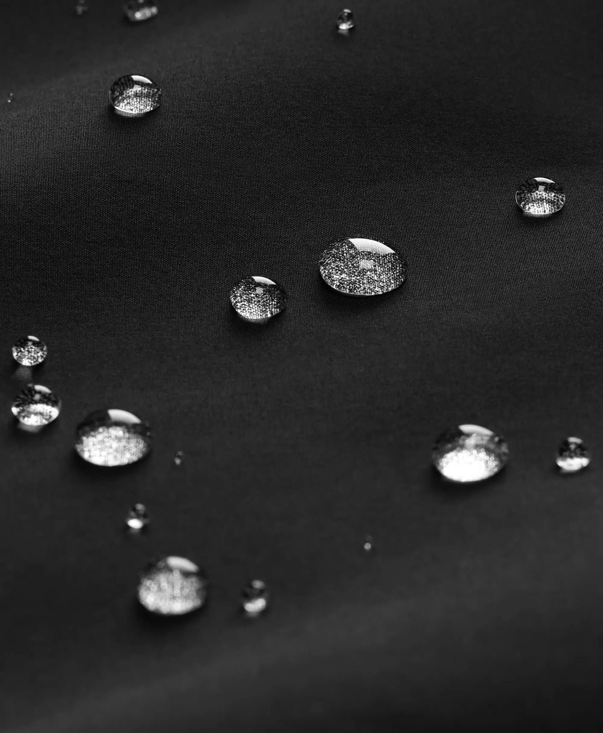 Water droplets beading on the jacket's water-repellent softshell fabric