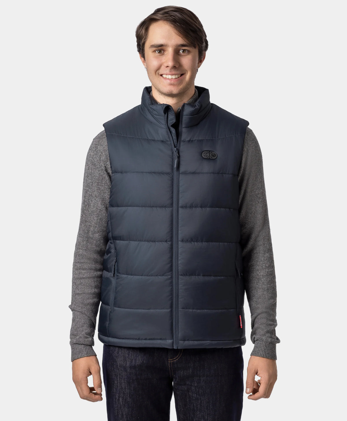 Man wearing an ororo Charcoal Slate heated puffer vest fully zipped over a gray sweater, shown from the front