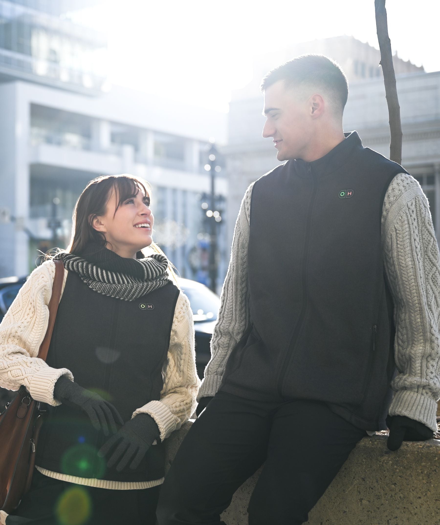 A man with the vest talking with a women outside