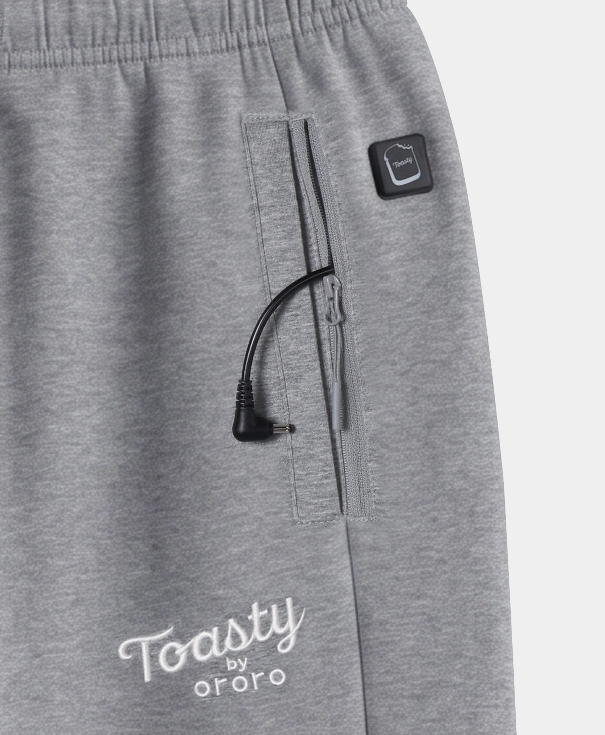 Close-up of Flecking Gray Toasty Heated Sweatpants showing side pocket, power button, and Toasty by ororo logo