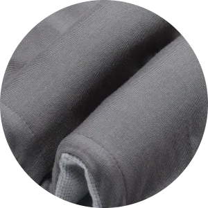 A close-up circular view of a folded gray towel or blanket showing both its soft plush texture and a lighter gray mesh-like underside.