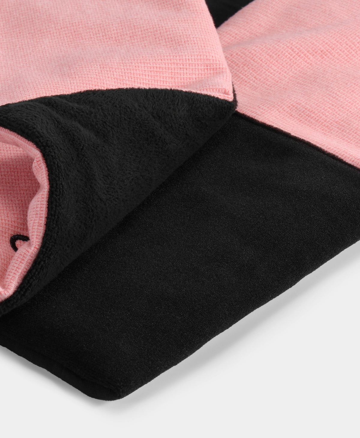 Close-up view of soft black fleece fabric with a pink lining